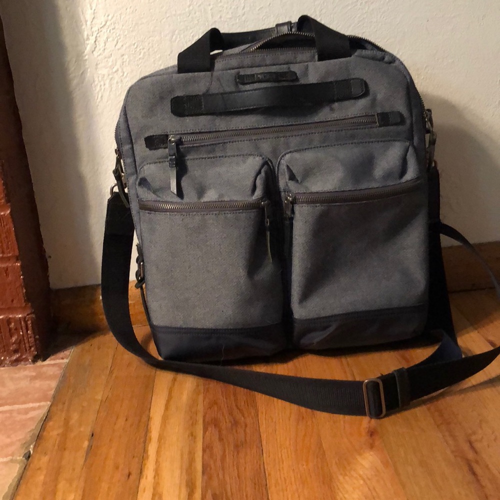 Grey TUMI messenger bag with laptop sleeve